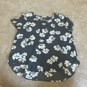 Grey blouse with white flowers.